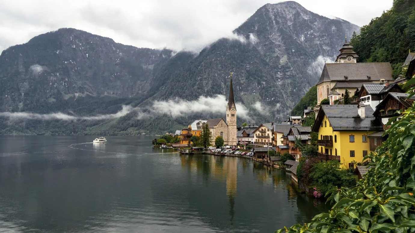 landscape-hallstatt-surrounded-by-water-rocky-mountains-rainy-day-austria_181624-45852